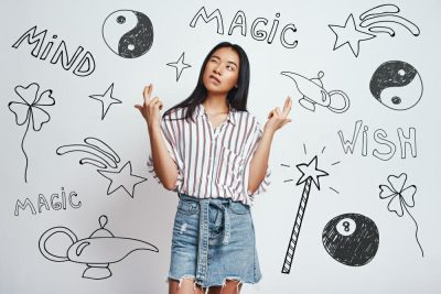 A young woman standing in front of a wall with a magical symbol drawn on it represents Amazon Product Liability Insurance.